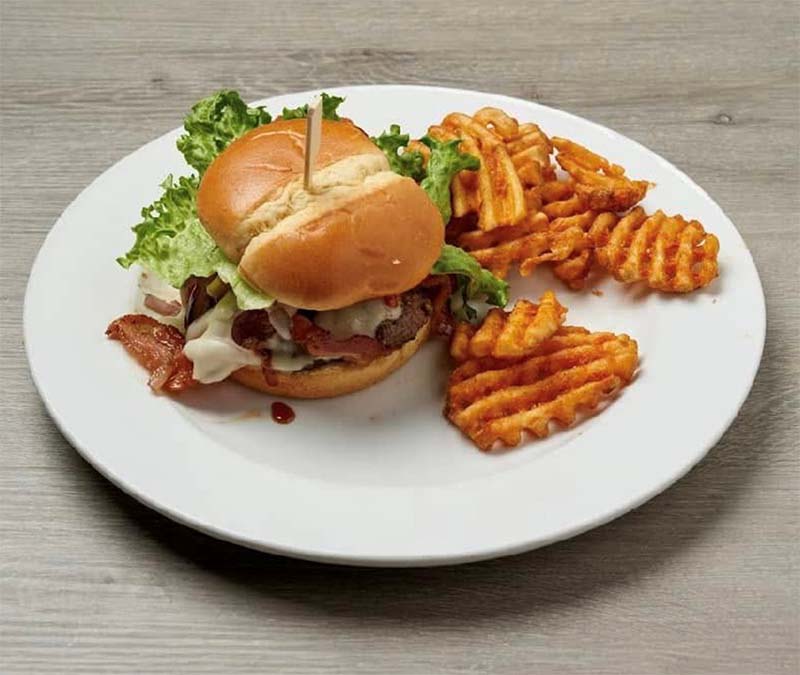 Burger with waffle fries at Blū Restaurant